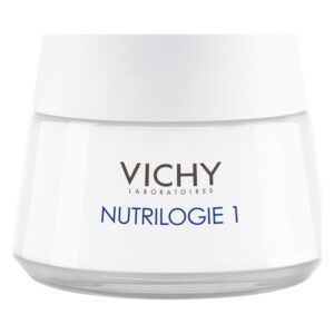Eine weiße Creme in einem Glasbehälter mit einem grauen Deckel, gekennzeichnet mit "VICHY NUTRILOGIE 1".