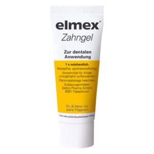 Weißes Tubengestell mit gelbem Etikett für elmex Zahngel zur dentalen Anwendung, rezeptfrei, apothekenpflichtig.
