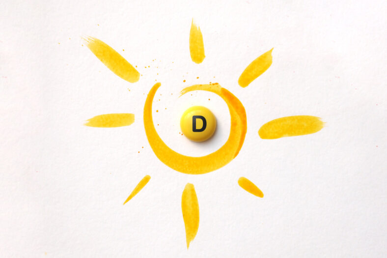 Gelbe Malerei eines Sonnenmotivs mit einer runden, gelben Pille mit dem Buchstaben D in der Mitte.