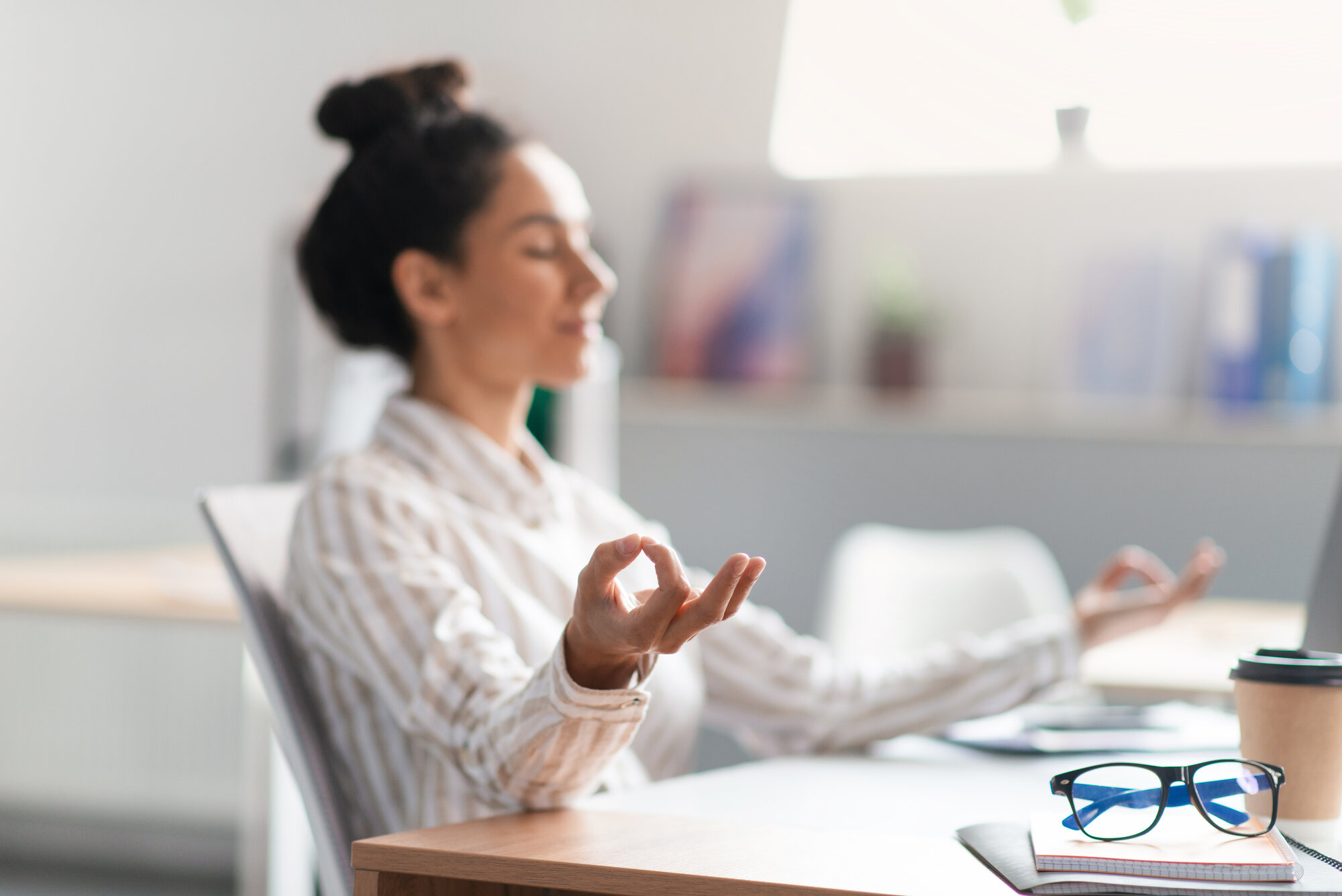 woman meditating office.jpeg